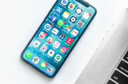 Smartphone and laptop showing a connected web and mobile experience